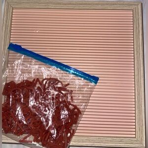 Pink letter board with red letters